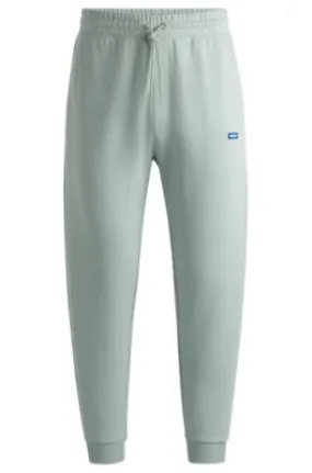 Cotton-terry tracksuit bottoms with blue logo patch