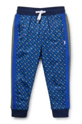 Kids' tracksuit bottoms with printed monograms and side stripes